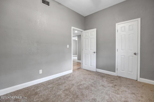 unfurnished bedroom with light carpet