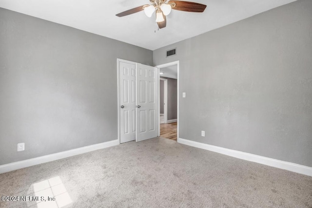 unfurnished bedroom with ceiling fan and carpet floors