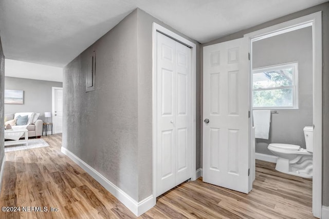 corridor with light wood-type flooring