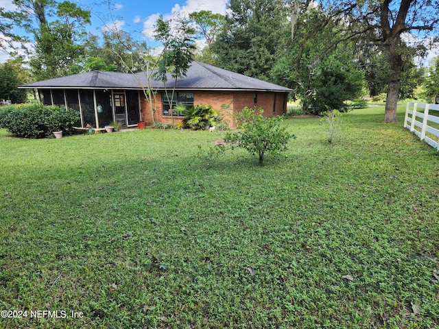 view of yard with a sunroom