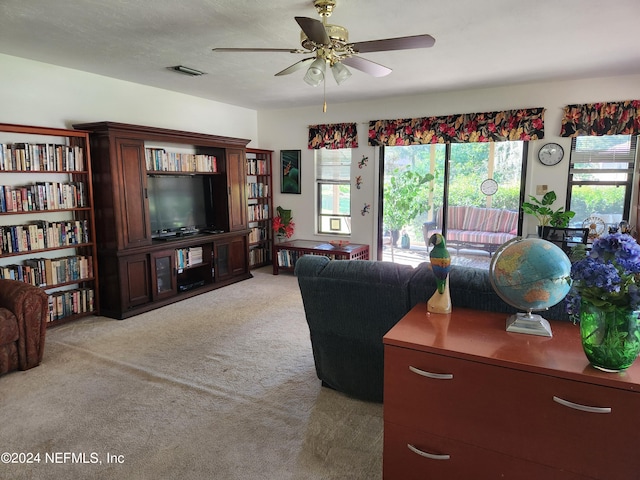 living room featuring light carpet and ceiling fan