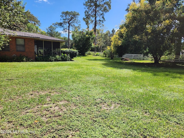 view of yard featuring a sunroom