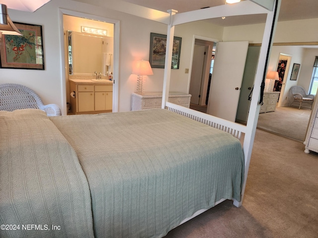 bedroom featuring ensuite bath, a closet, carpet floors, and sink