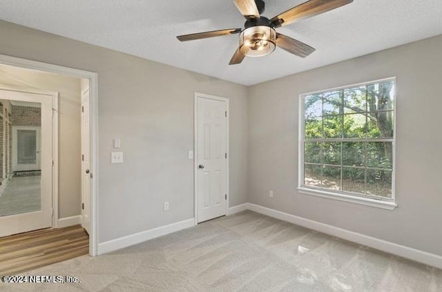 unfurnished bedroom featuring ceiling fan and light colored carpet