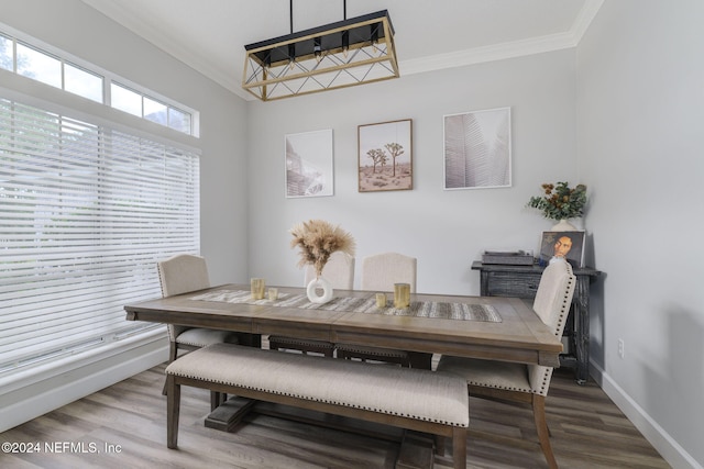 dining room with hardwood / wood-style floors and ornamental molding