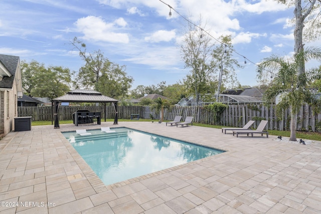 view of pool with a patio, a jacuzzi, and a gazebo