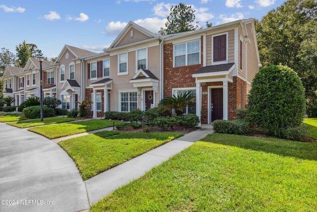 townhome / multi-family property featuring a front yard