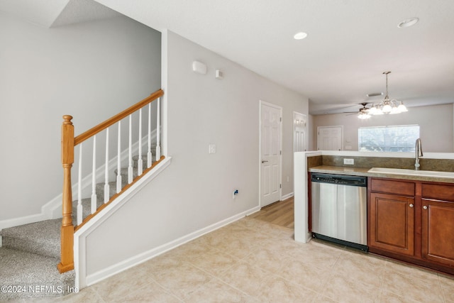 kitchen featuring light tile patterned floors, stainless steel dishwasher, sink, and a chandelier