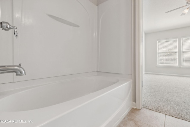 bathroom featuring tile patterned flooring, ceiling fan, and a washtub