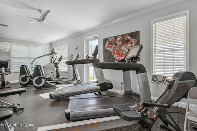 gym with ceiling fan and crown molding