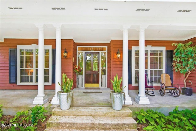 doorway to property featuring covered porch