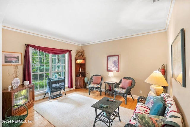 living room with light hardwood / wood-style floors and crown molding