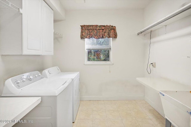 washroom featuring separate washer and dryer and cabinets