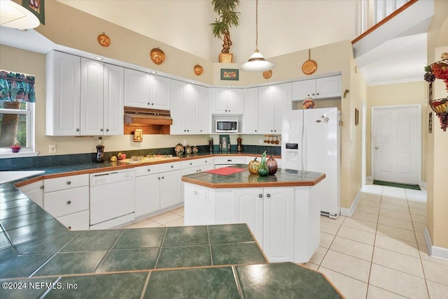 kitchen featuring range hood, white appliances, white cabinetry, and decorative light fixtures