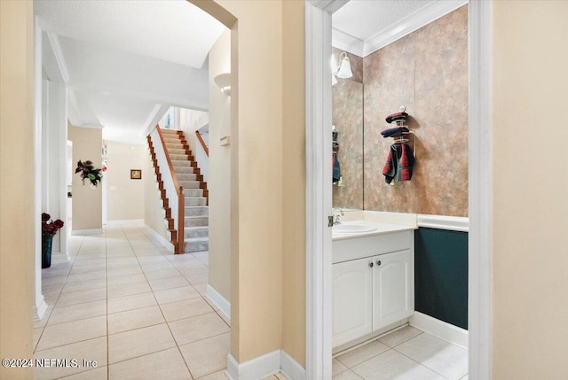 bathroom featuring crown molding, tile patterned flooring, and vanity