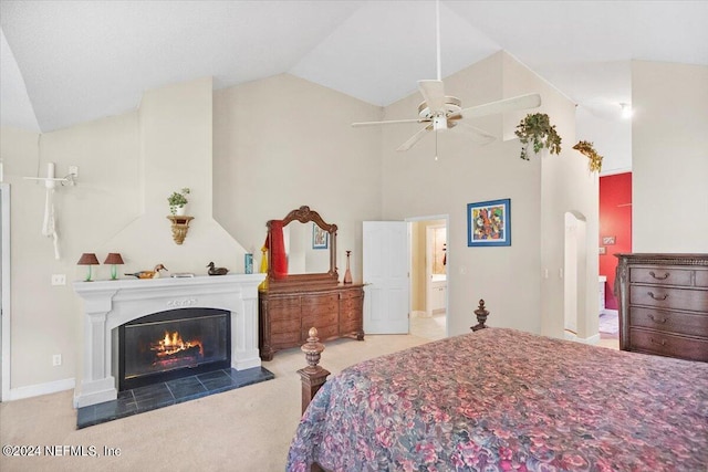 carpeted bedroom featuring connected bathroom, vaulted ceiling, and ceiling fan