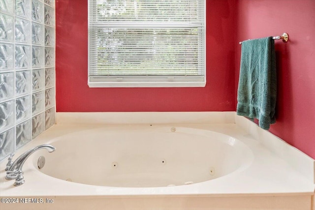 bathroom with a healthy amount of sunlight and a tub