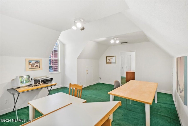 carpeted office space featuring vaulted ceiling