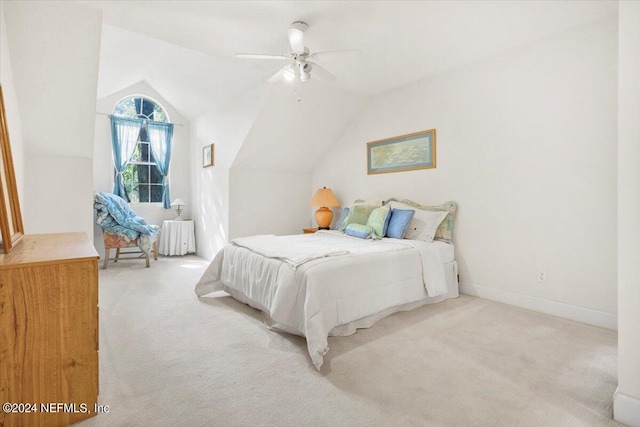 bedroom featuring light carpet, lofted ceiling, and ceiling fan