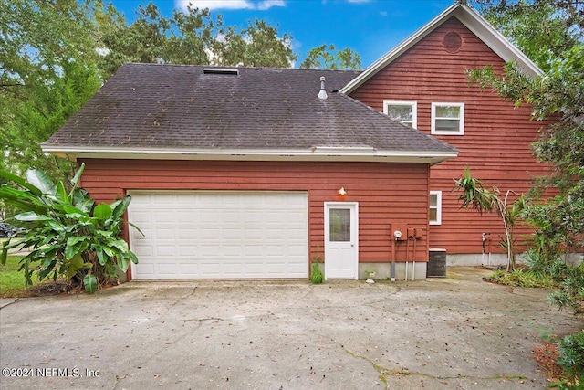 back of house with a garage