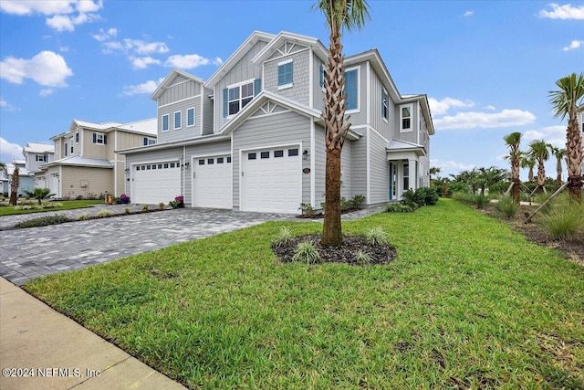 view of front of home with a front yard and a garage