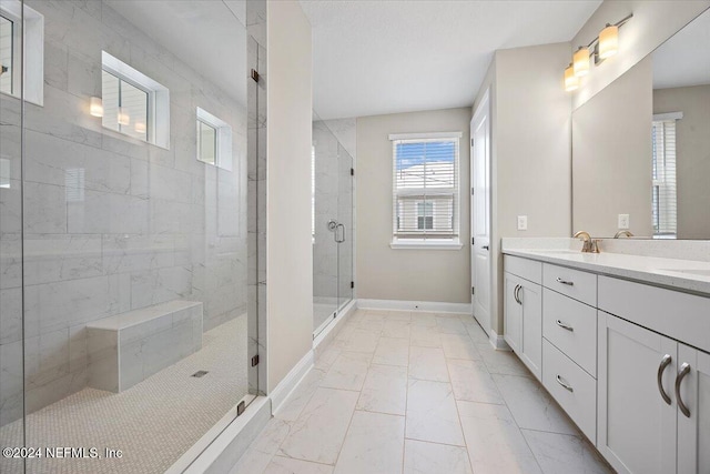 bathroom with vanity and a shower with shower door