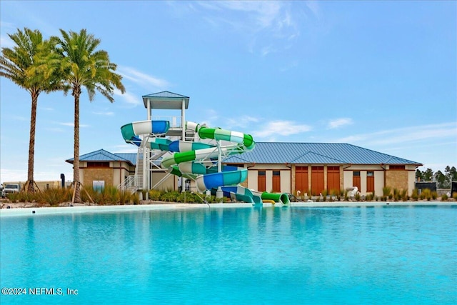 view of swimming pool with a water slide