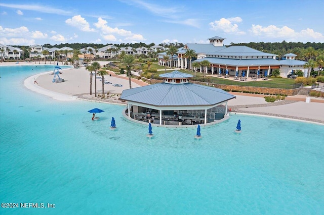 view of swimming pool featuring a gazebo and a water view