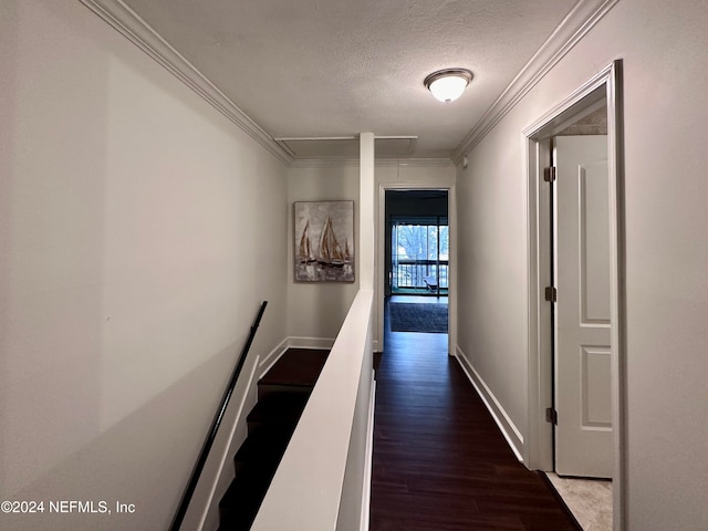 corridor featuring hardwood / wood-style floors, a textured ceiling, and crown molding