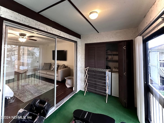 sunroom with washer and dryer and ceiling fan