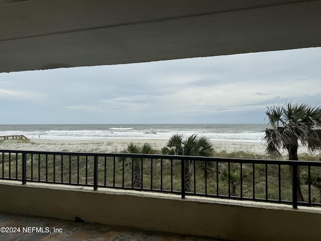 balcony with a beach view and a water view