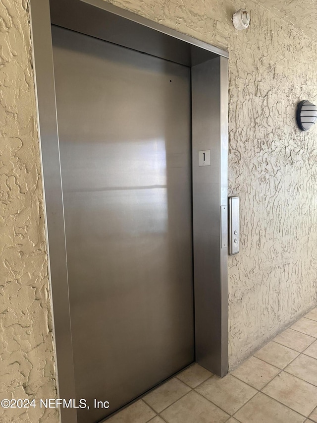 details with tile patterned floors and elevator