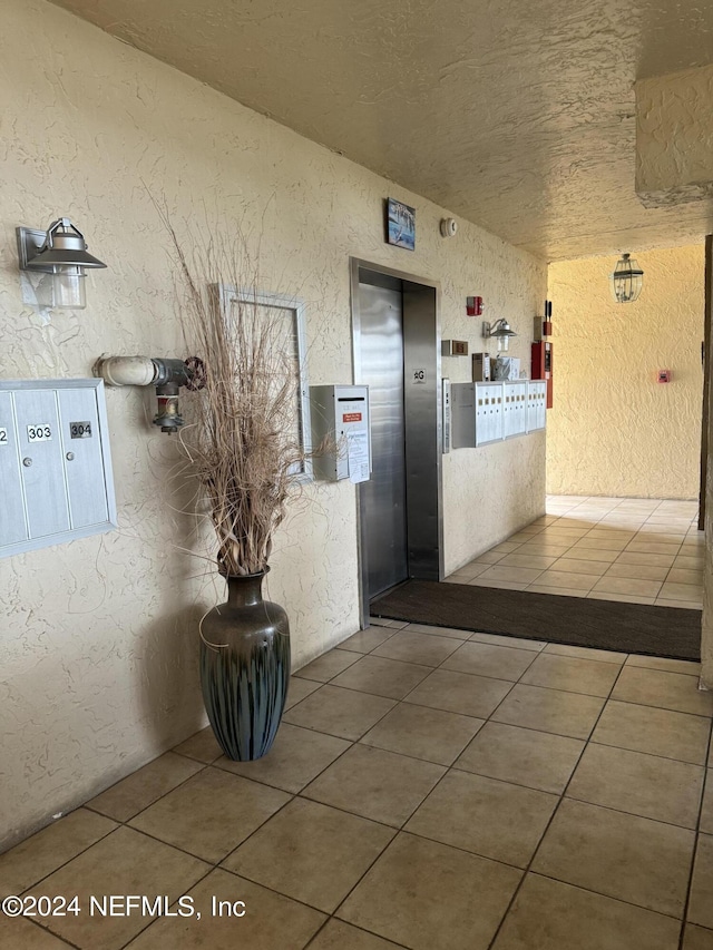 hallway with mail boxes and elevator