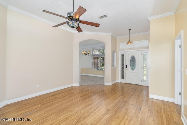 entryway featuring ornamental molding, light hardwood / wood-style floors, ceiling fan with notable chandelier, and a textured ceiling