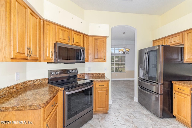 kitchen featuring dark stone countertops, decorative light fixtures, a notable chandelier, and stainless steel appliances