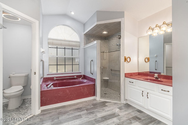 full bathroom with vanity, toilet, hardwood / wood-style flooring, shower with separate bathtub, and vaulted ceiling