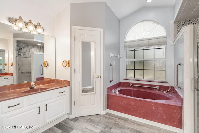 bathroom featuring independent shower and bath, vanity, hardwood / wood-style floors, and vaulted ceiling