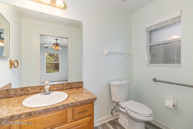 bathroom featuring vanity, toilet, ceiling fan, and hardwood / wood-style flooring