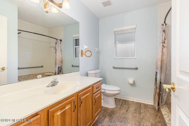 bathroom with vanity, toilet, a shower with shower curtain, and hardwood / wood-style flooring