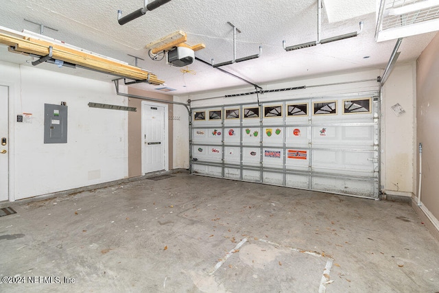 garage with a garage door opener and electric panel