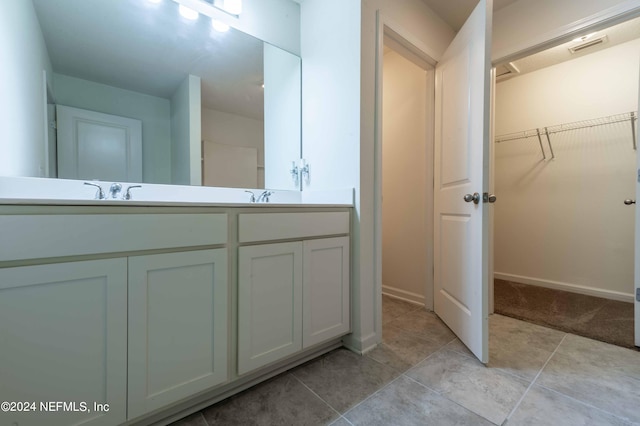 bathroom with tile patterned floors and vanity