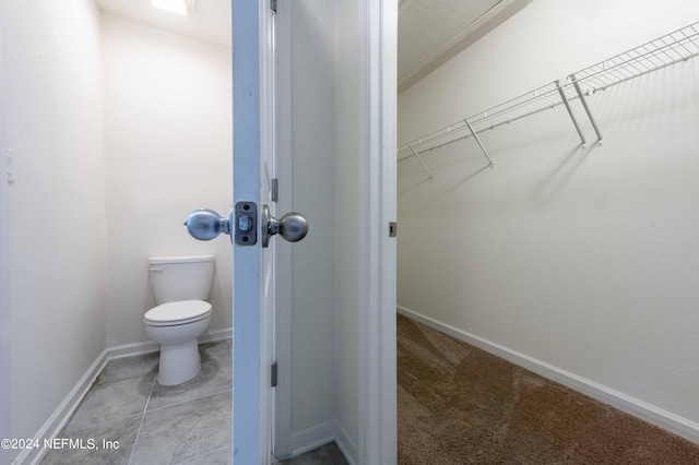 bathroom featuring tile patterned floors and toilet