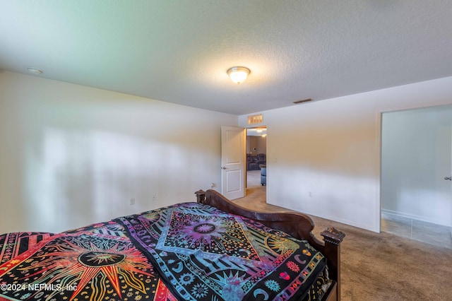 carpeted bedroom with a textured ceiling