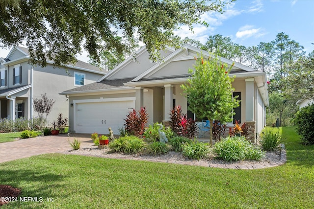 view of front of house featuring a front yard and a garage