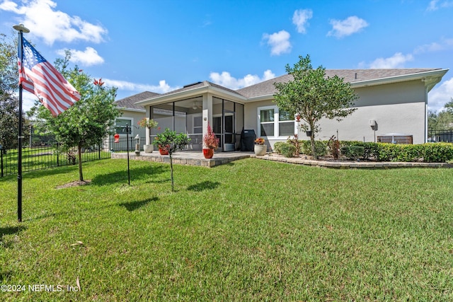 view of front of property featuring a front lawn and a sunroom