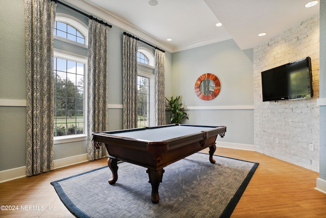 rec room with pool table, crown molding, light hardwood / wood-style flooring, and a wealth of natural light