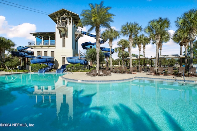 view of swimming pool with a water slide