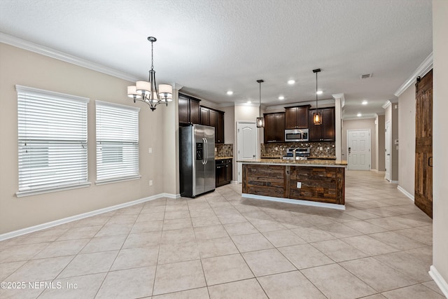 kitchen with stainless steel appliances, pendant lighting, crown molding, and an island with sink