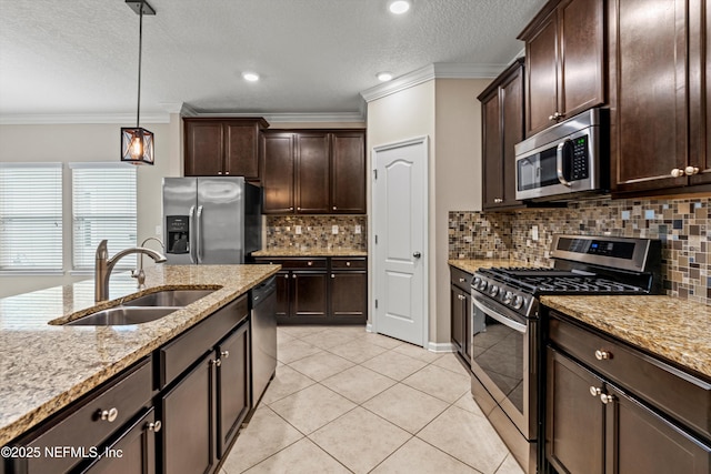 kitchen featuring decorative backsplash, appliances with stainless steel finishes, hanging light fixtures, and sink