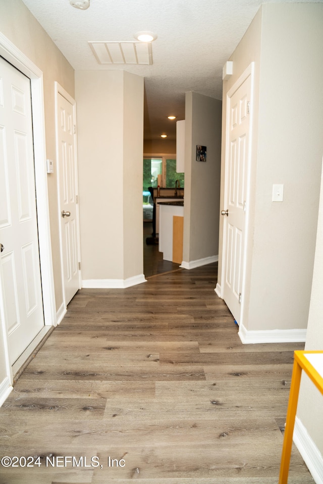 hall with wood-type flooring